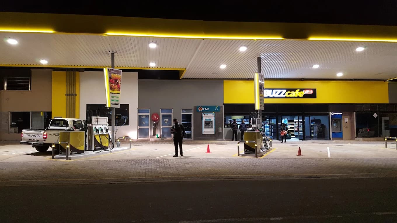 MBT Poppys Ventersdorp forecourt and fuel pumps lit up at night, 38 Hendrik Potgieter Street Ventersdorp